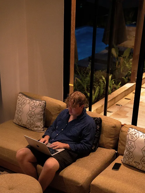 Finn working on a laptop on a sofa